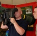 Marine Sgt. Watches as Visitor Examines Anti-Tank Missile Launcher