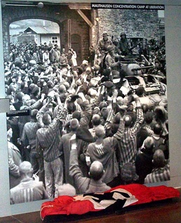 Haunting Image Juxtaposes Nazi Flag, Concentration Camp Victims