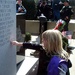 Solemn Remembrance: Daughter Touches Memorial for 14th Quartermaster Detachment