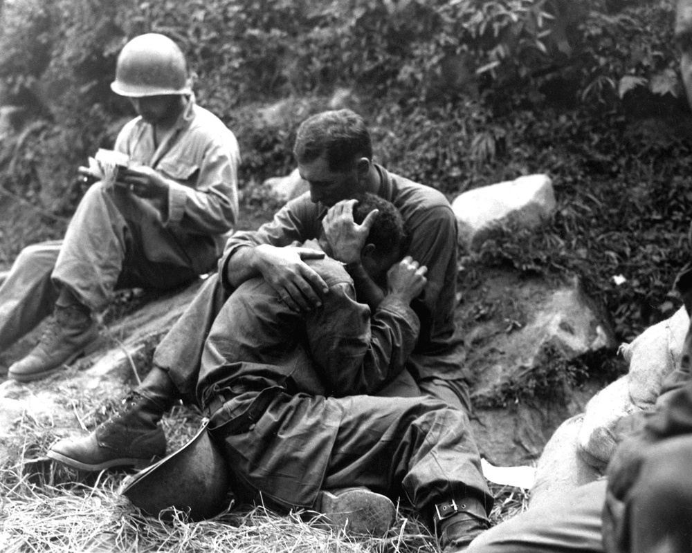 Grief and Duty: Soldier Comforts Fallen Comrade as Corpsman Documents Casualties in Korea