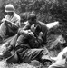Grief and Duty: Soldier Comforts Fallen Comrade as Corpsman Documents Casualties in Korea