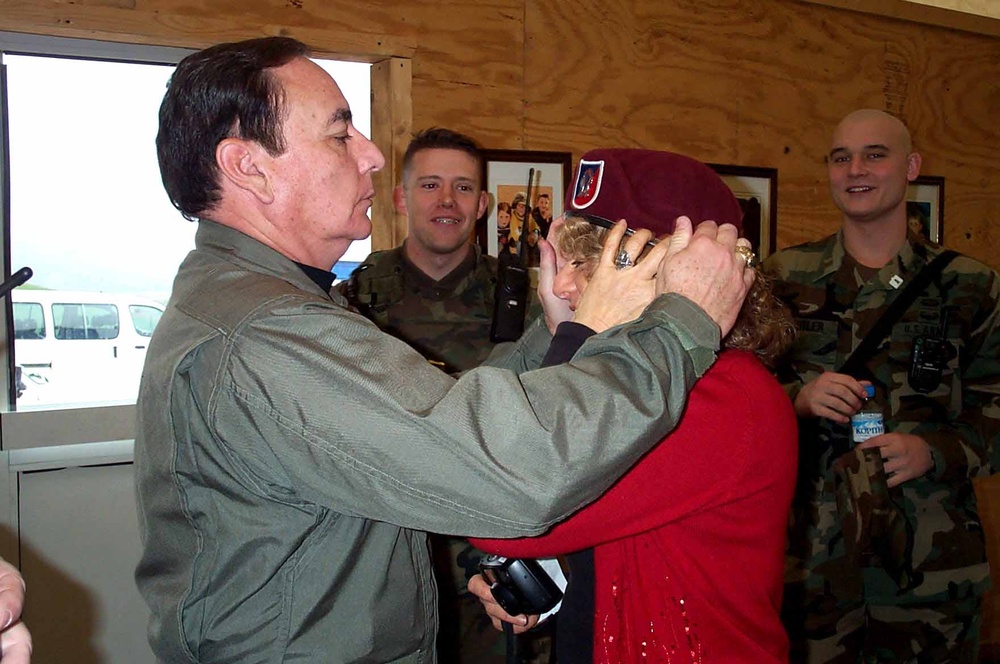 Medal of Honor Recipient Helps Singer Adjust Beret During Kosovo Visit
