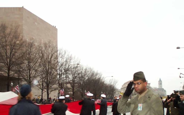 Military Members Salute as Oversized Flag Marches Down Pennsylvania Avenue
