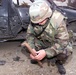 U.S. Soldier Examines Mortar Crater After Deadly Attack in Kosovo