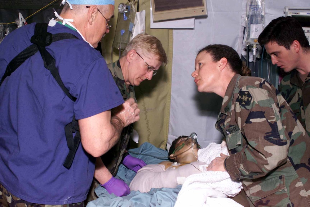 U.S. Soldiers Tend to Wounded Albanian Civilian in Kosovo
