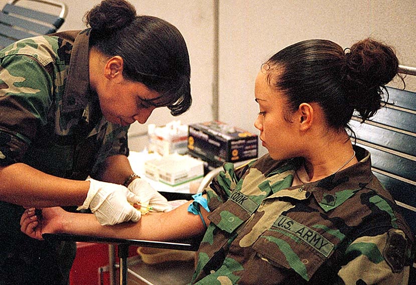 Army Medic Draws Blood Sample from National Guardsman Deploying to Bosnia