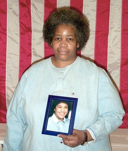 Grieving Sister Holds Photo of 9/11 Victim