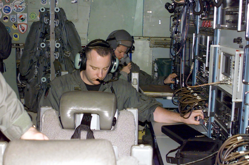 Air Force Crew Member Adjusts Broadcast Signal During Training Mission