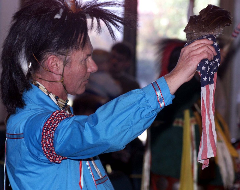 Powwow Participant Holds American Flag During Veterans Song