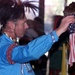 Powwow Participant Holds American Flag During Veterans Song