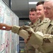 Air Force Personnel Examine Banner of Well-Wishes from Shaw Air Force Base