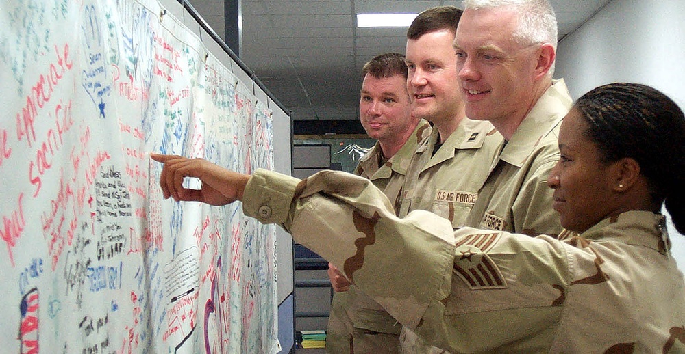 Air Force Personnel Examine Banner of Well-Wishes from Shaw Air Force Base