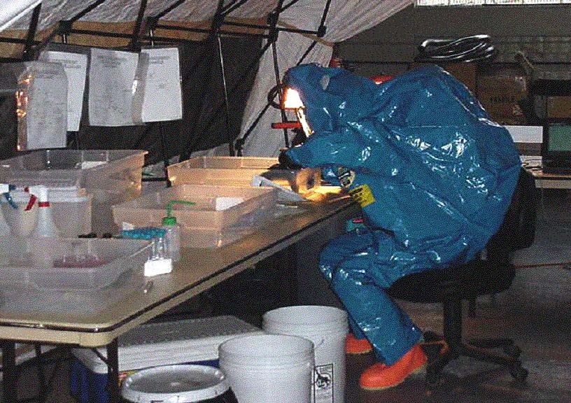 Hazmat-Suited Specialist Tests Samples from Survey Team