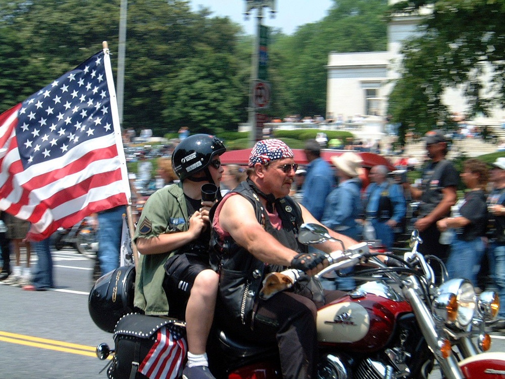 Biker Carries American Flag in Rolling Thunder Ride