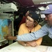 Businesswoman Learns About Navigational Aids from Sailor