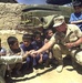 U.S. Army Officer Distributes Candy to Afghan Children at School Near Bagram Air Base