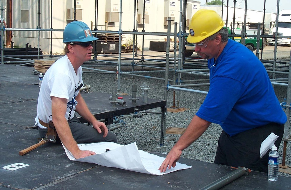 Workers Examine Blueprints for Pentagon 9/11 Ceremony Stage