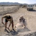 Army Engineer Collaborates with Local Worker on Road Project in Afghanistan