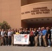 Joint Civilian Orientation Conference Participants Pose with America Supports You Banner in Bahrain