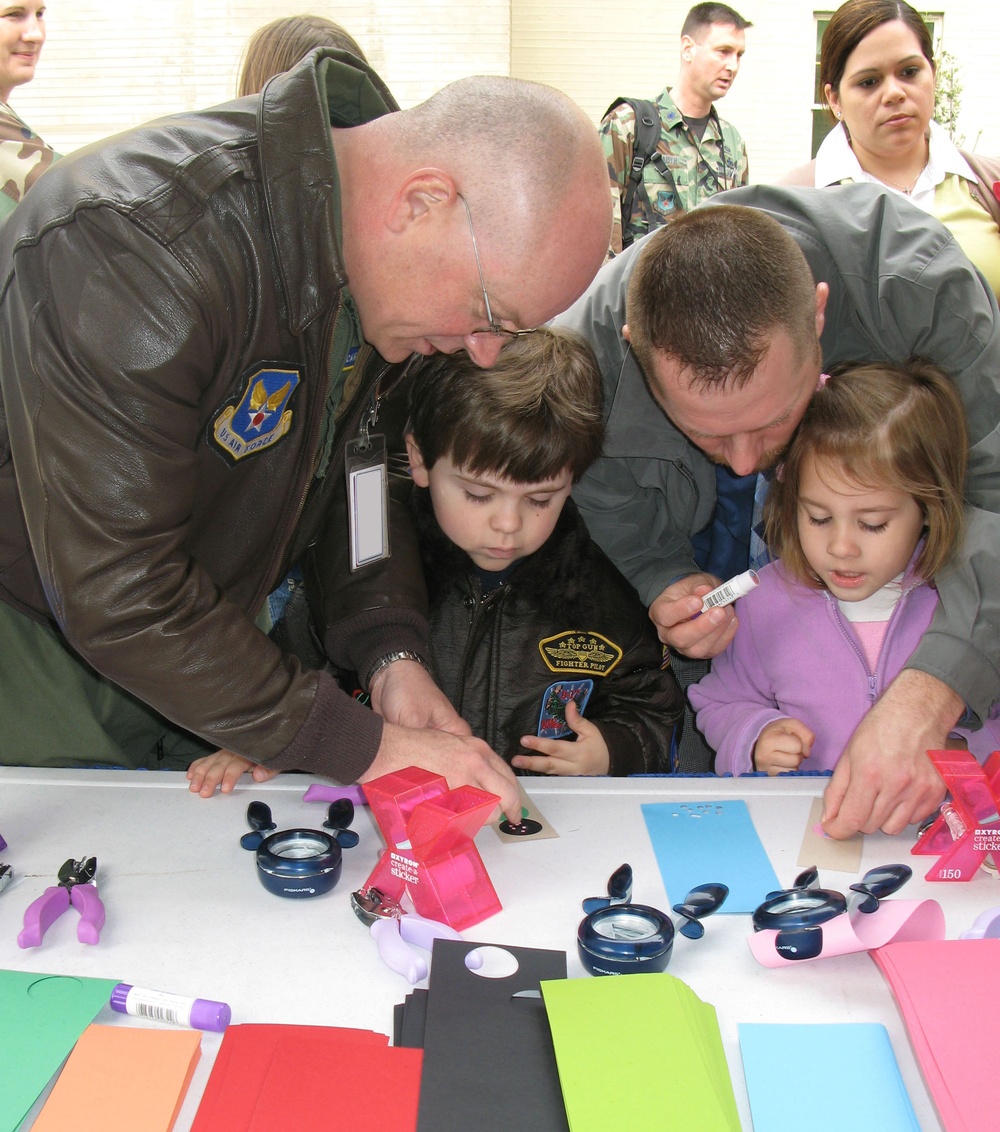 Air Force Colonel Helps Son Cut Shapes at Pentagon's Take Your Child to Work Day