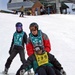 Disabled Veteran Skis with Volunteer Instructors at Winter Sports Clinic