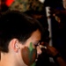 Young Student Learns Camouflage Face Painting at Marine Corps Exhibit