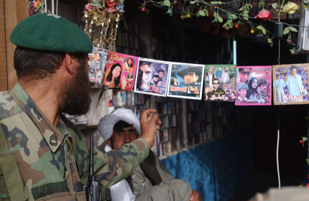 Platoon Sgt. Alladad Browses Music at Village Shop