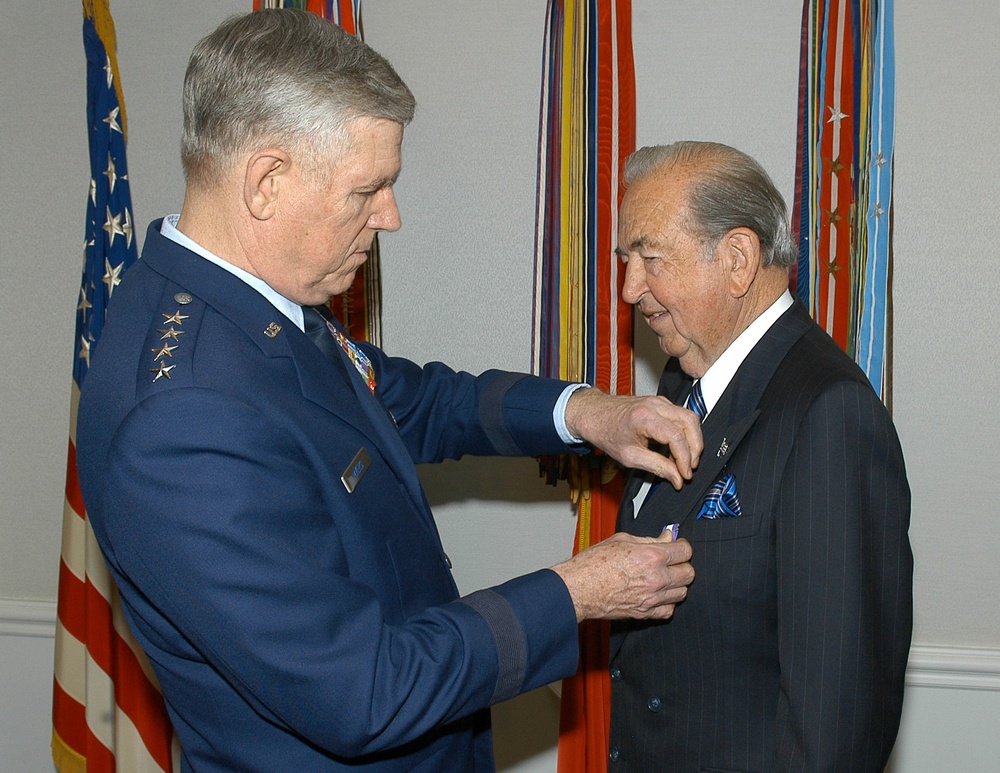 Air Force General Honors Retired Major General for Humanitarian Work