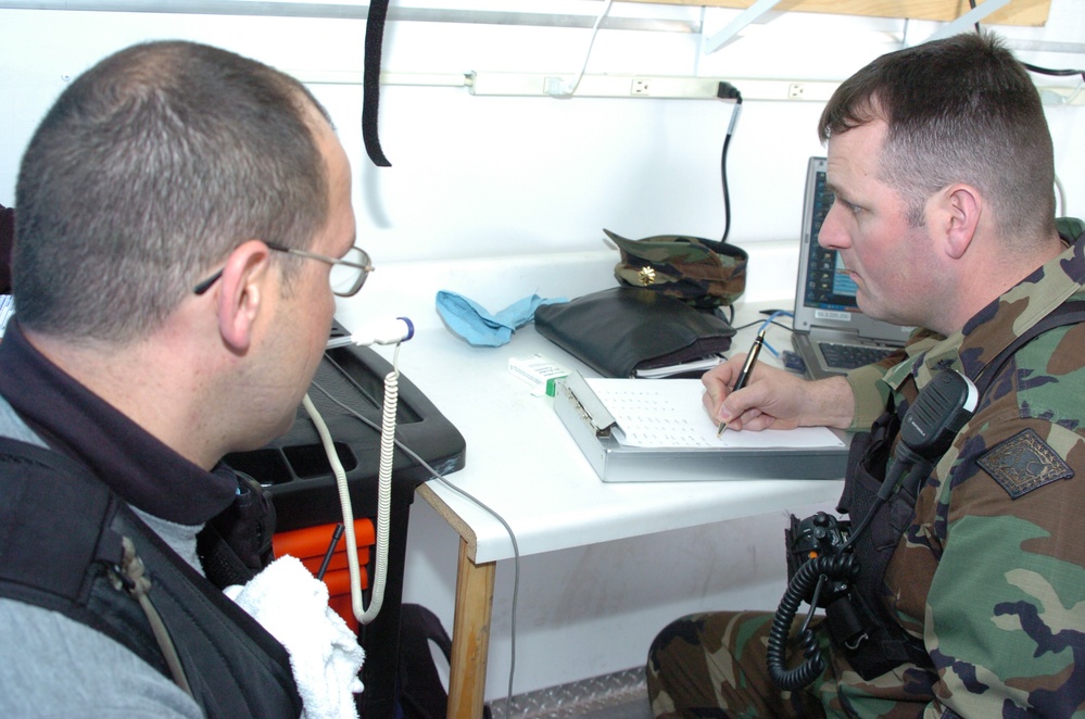 Army Medical Officer Examines Soldier After Sampling Exercise