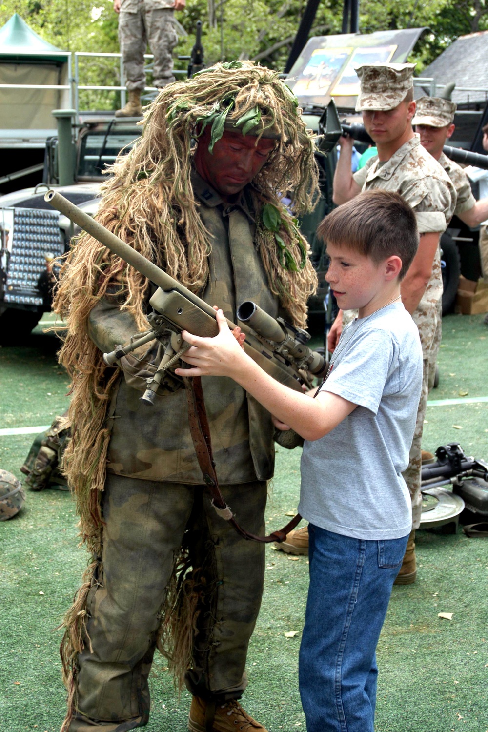 Marine Officer Lets Child Handle Sniper Rifle at Fleet Week Event