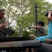 Young Siblings Fascinated by Marine Corps Humvee at Fleet Week Event