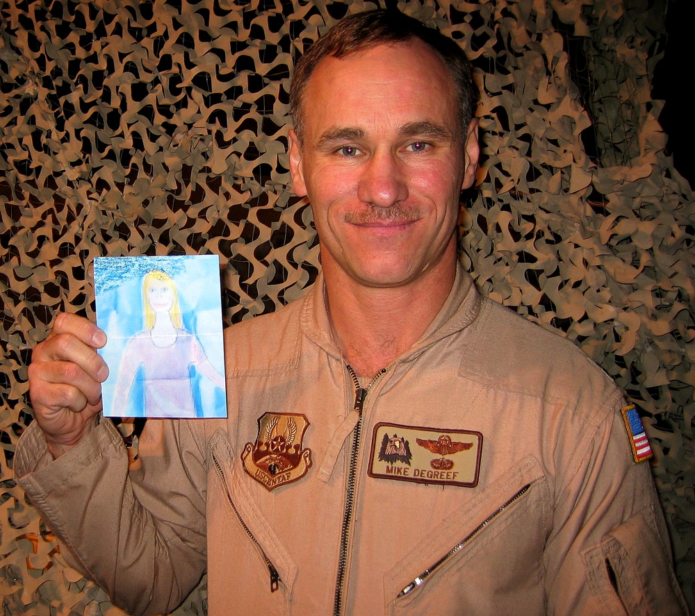 Air Force Lt. Col. Poses with Daughter's Drawing of Herself
