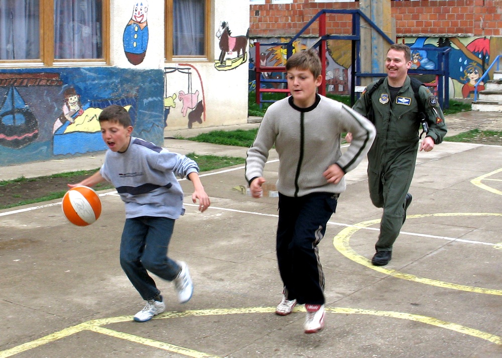 Air Force Major Engages with Local Children During Pristina Visit