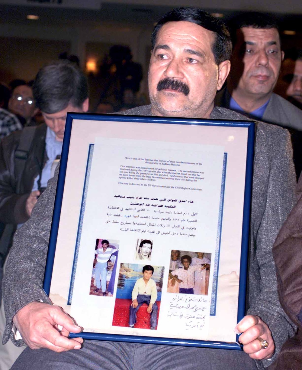 Iraqi Man Holds Poster Honoring Family Killed in 1991 Uprisings