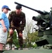 Soldier Gives Boy a Lift on Army Vehicle at Public Service Event
