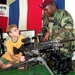 Young Boy Learns About Army Weaponry at Public Service Event