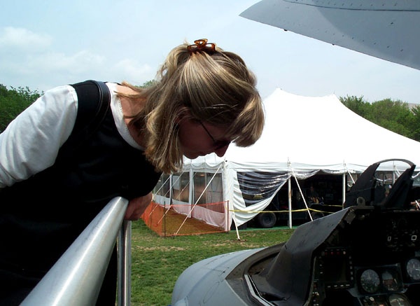 Air Force Pilot Inspects F-16 Fighter Jet at Public Service Event