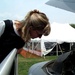 Air Force Pilot Inspects F-16 Fighter Jet at Public Service Event