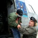 Marine Reservist Helps Young Boy Disembark Helicopter at Air Show