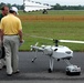 Visitor Inspects Schiebel Camcopter During UAV Demo at Naval Air Station
