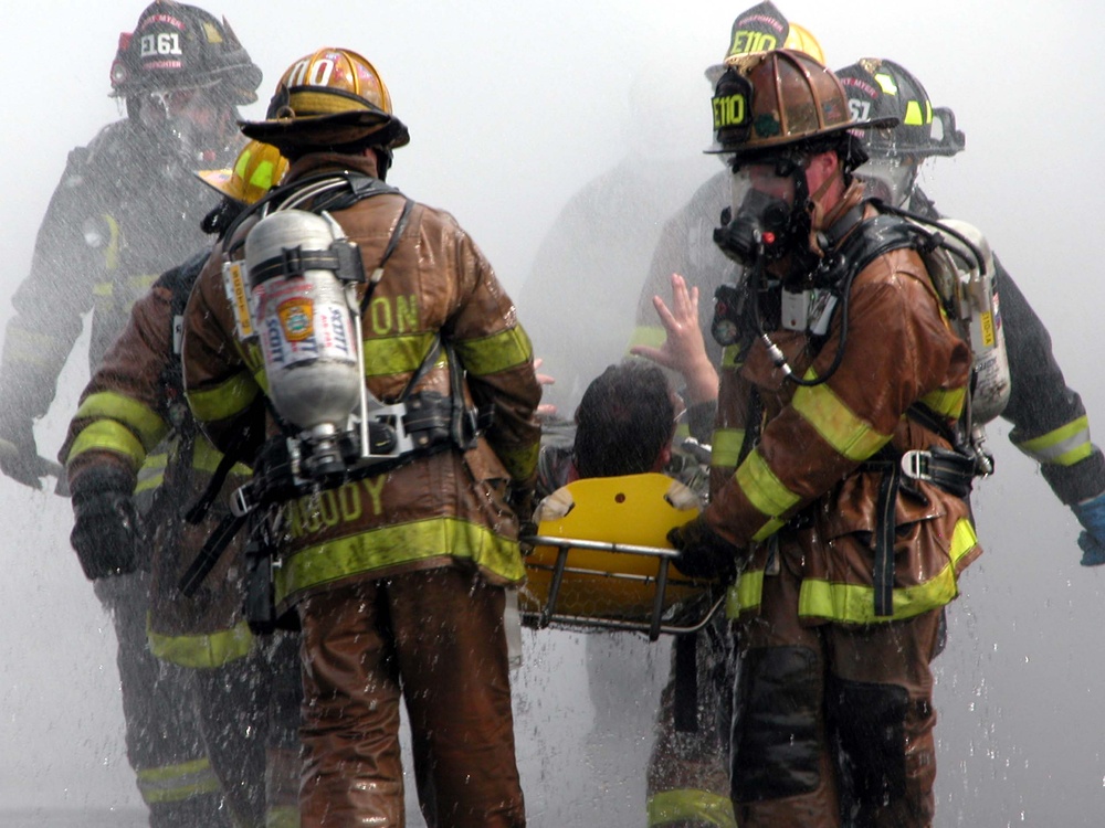 Firefighters Assist Injured Volunteers in Pentagon Decontamination Exercise