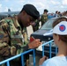 Airman Shares American Currency with Russian Girl at Moscow Air Show