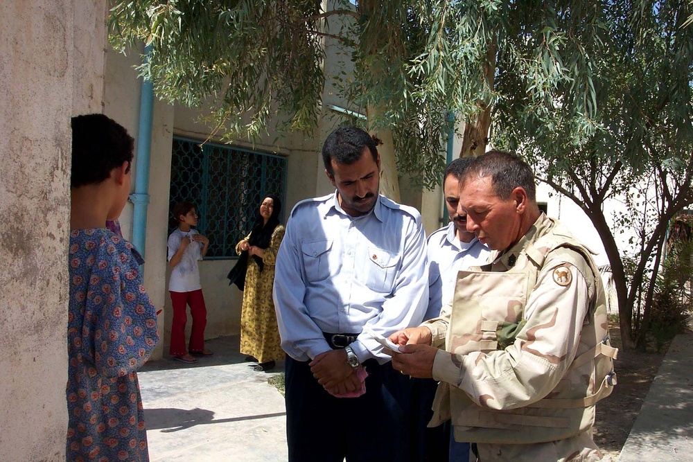 Army NCO Uses Language Guide to Assist Iraqi Officials