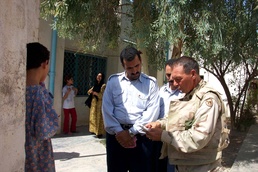 Army NCO Uses Language Guide to Assist Iraqi Officials