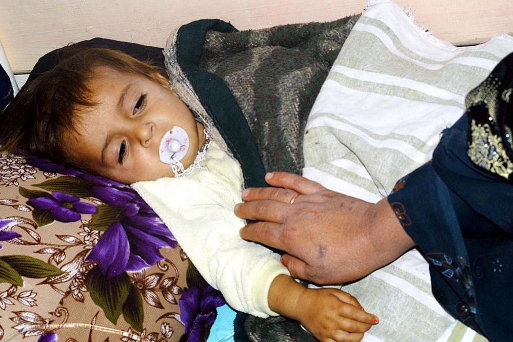 Iraqi Mother Comforts Sick Child at Newly Opened Sinjar Hospital