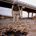 Chemical Officer Inspects Oil Spill in Iraqi Waterway