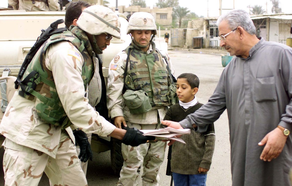 Soldiers Distribute Local Newspaper to Iraqi Citizens