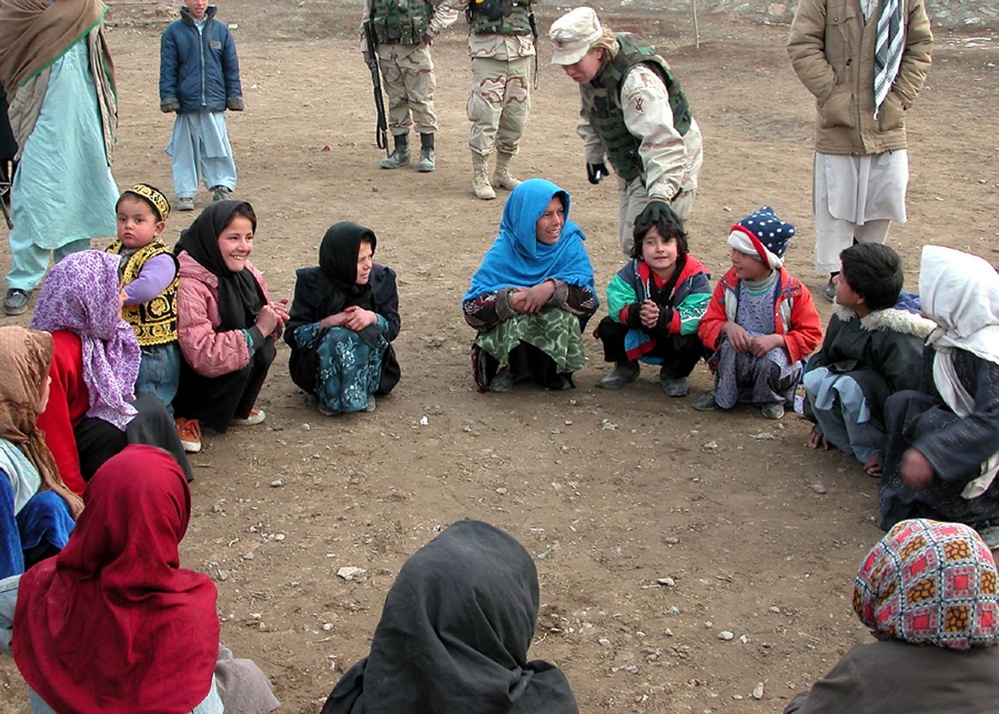 U.S. Troops Engage Afghan Children in Playful Game at Orphanage