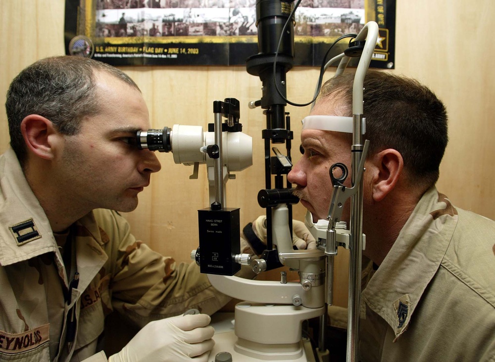Army Ophthalmologist Examines Soldier's Eyes at Bagram Clinic