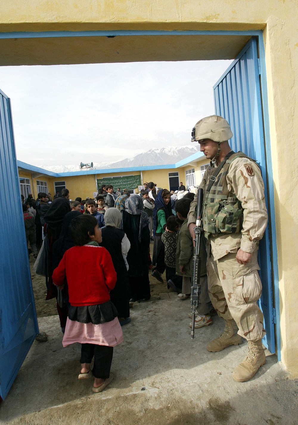 U.S. Soldier Engages with Afghan Girl at Newly Renovated School